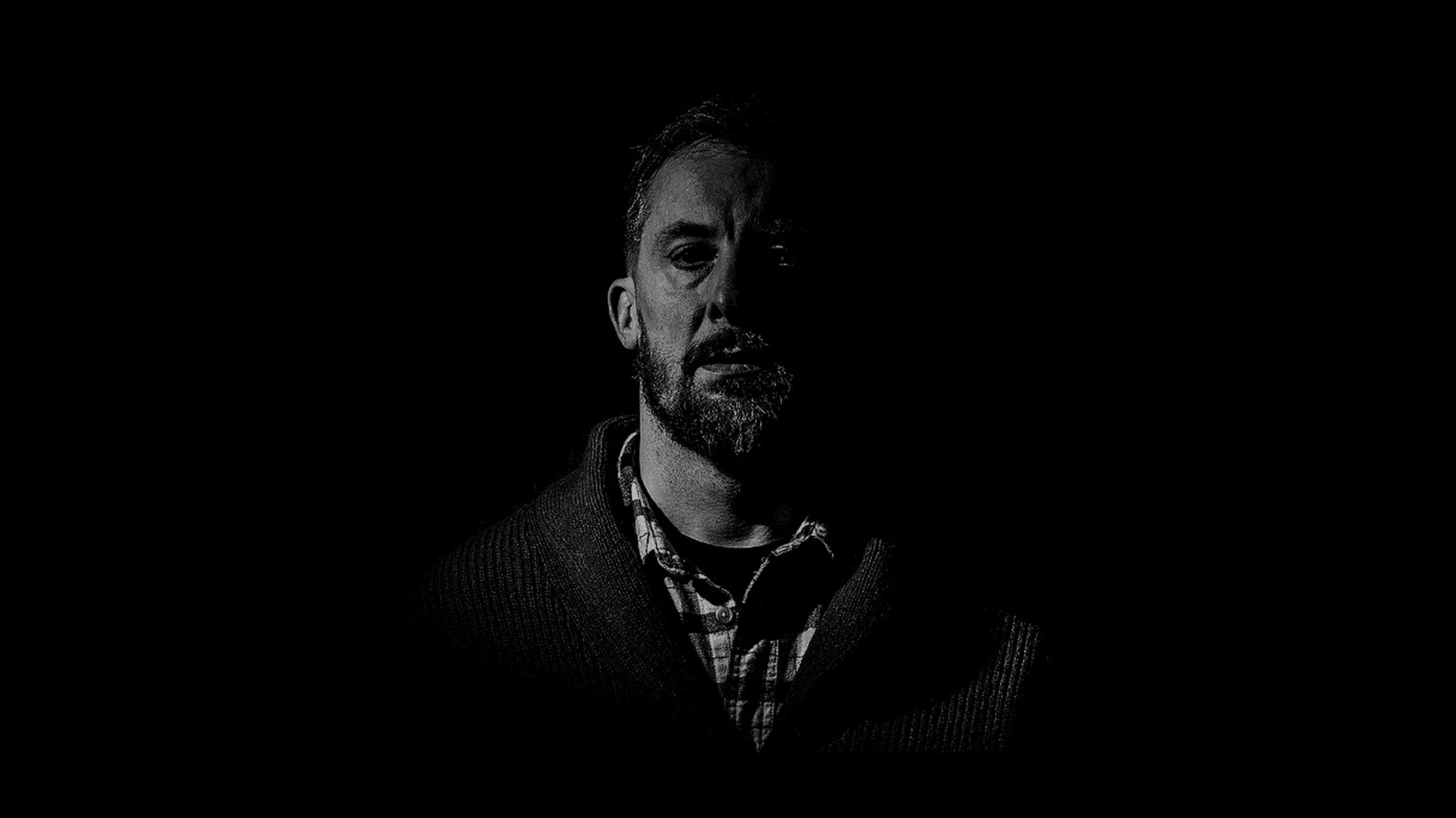 Portrait of Nate Johnson against a black background